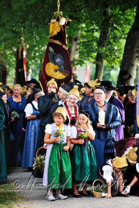 girls in traditional clothes with herb-baskets