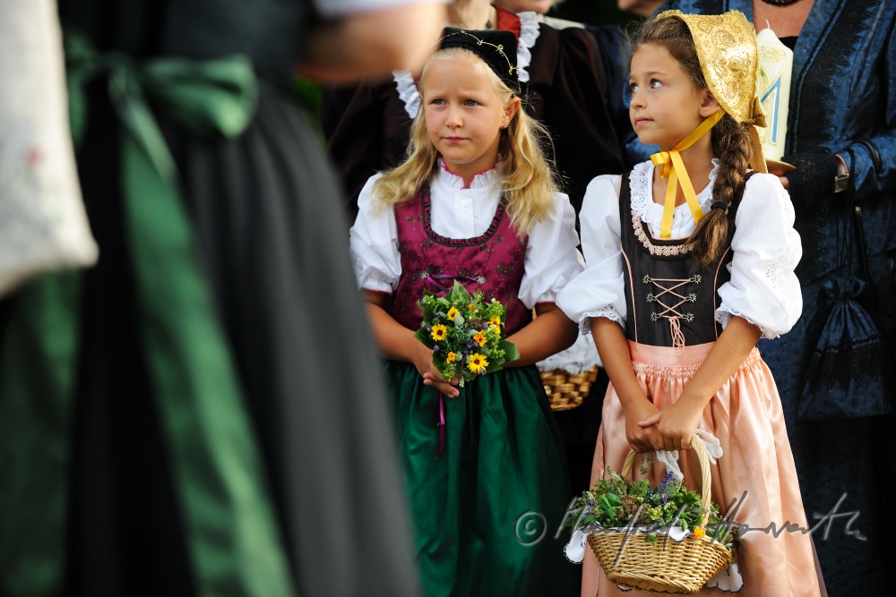 girls in traditional clothes with herb-baskets