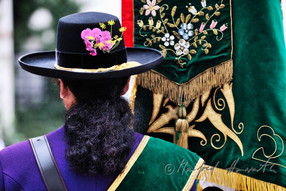 man with ponytail and flag in the church