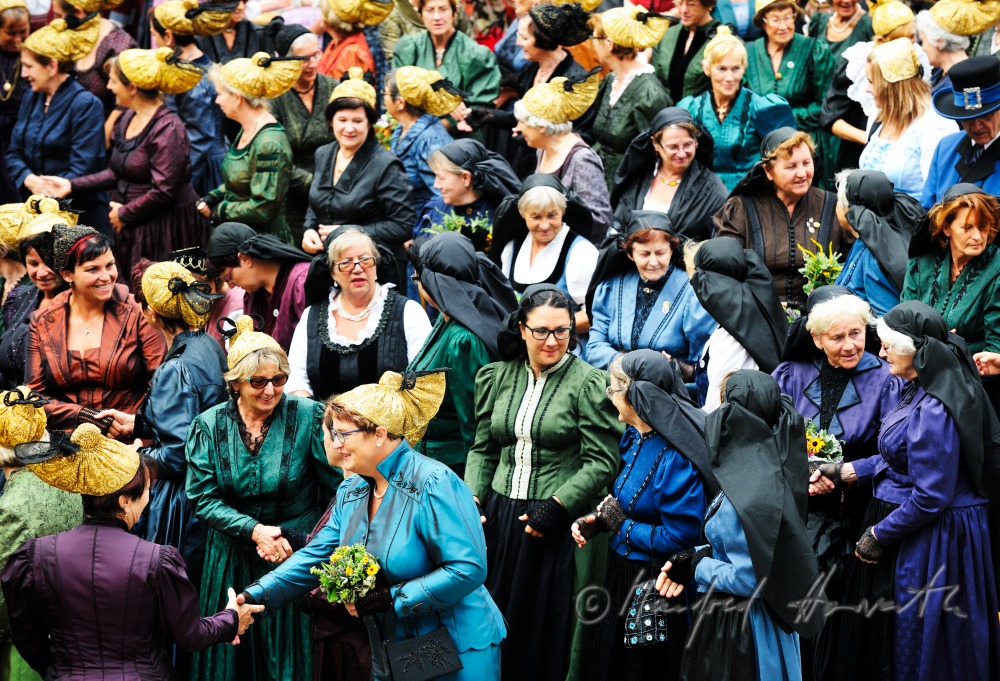 attendants of the open air mass in traditional clothes