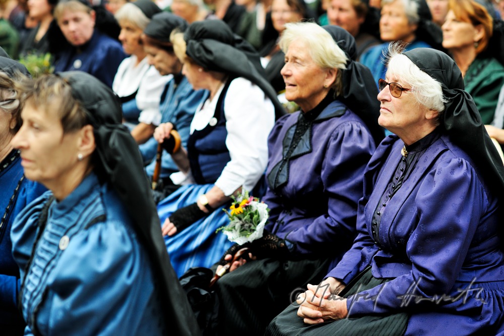 attendants of the open air mass in traditional clothes