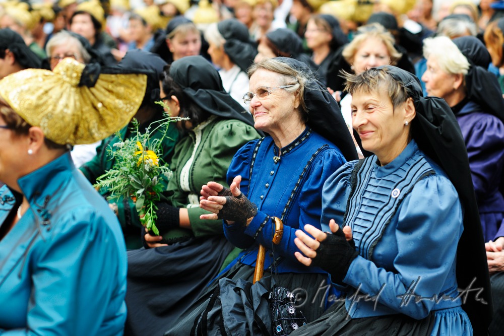 attendants of the open air mass in traditional clothes