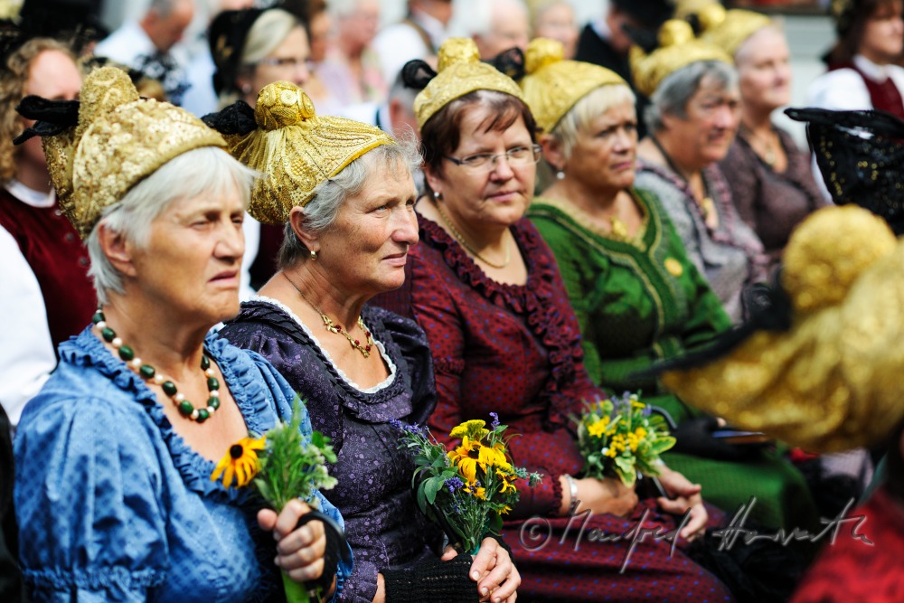 attendants of the open air mass in traditional clothes