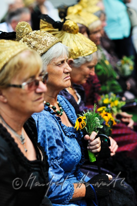 attendants of the open air mass in traditional clothes