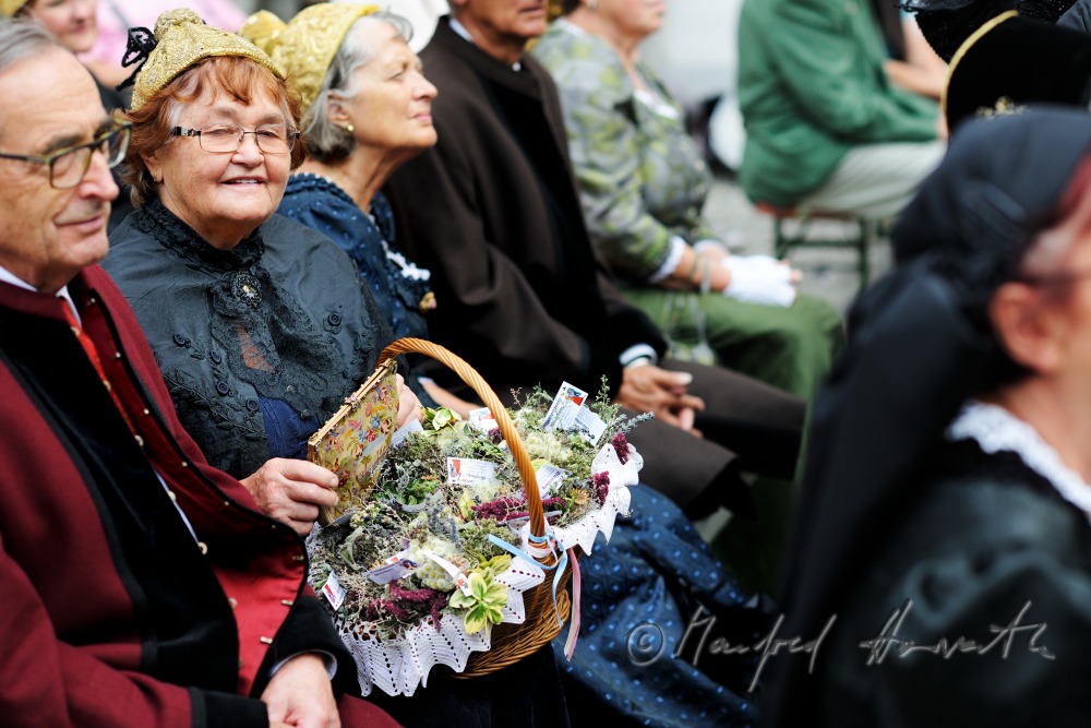 attendants of the open air mass in traditional clothes
