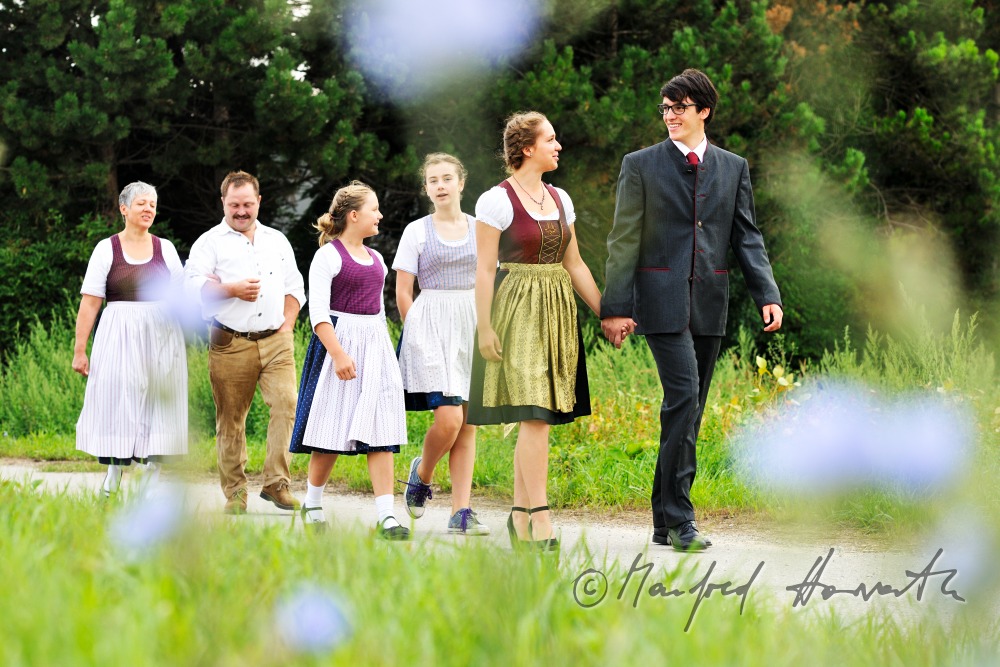 family going to church on Sunday in traditional dresses