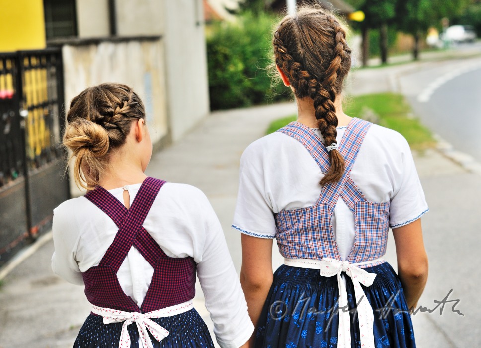 family going to church on Sunday in traditional dresses