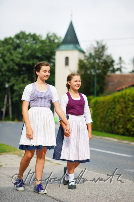 family going to church on Sunday in traditional dresses
