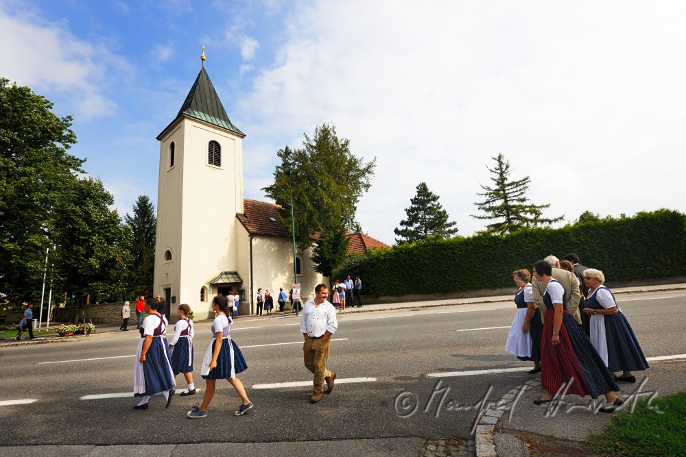 family going to church on Sunday in traditional dresses