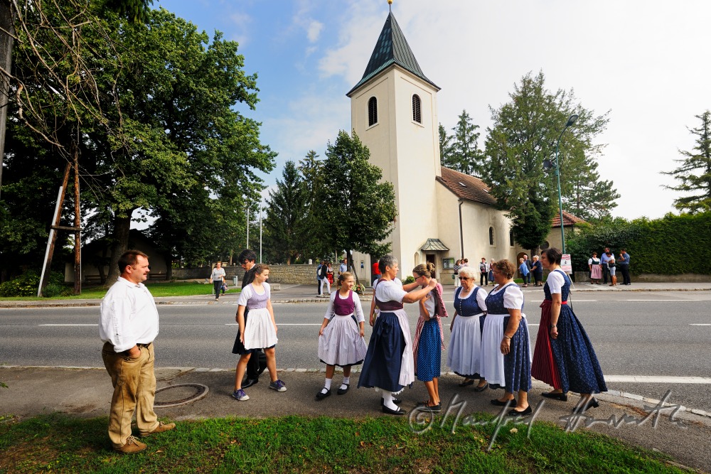 family going to church on Sunday in traditional dresses