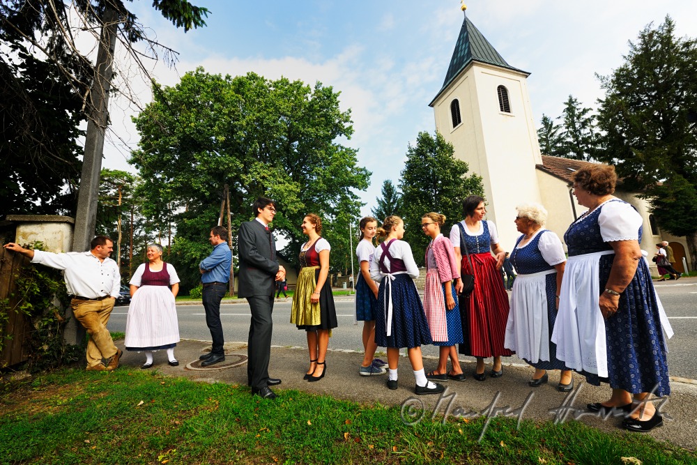 family going to church on Sunday in traditional dresses