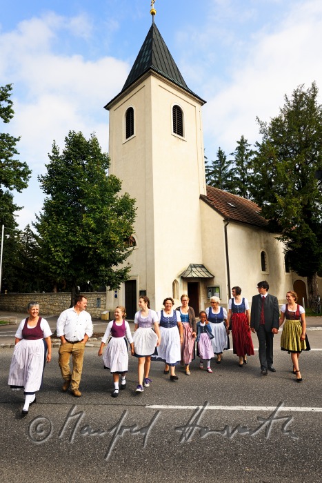 family coming out from church on Sunday in traditional dresses