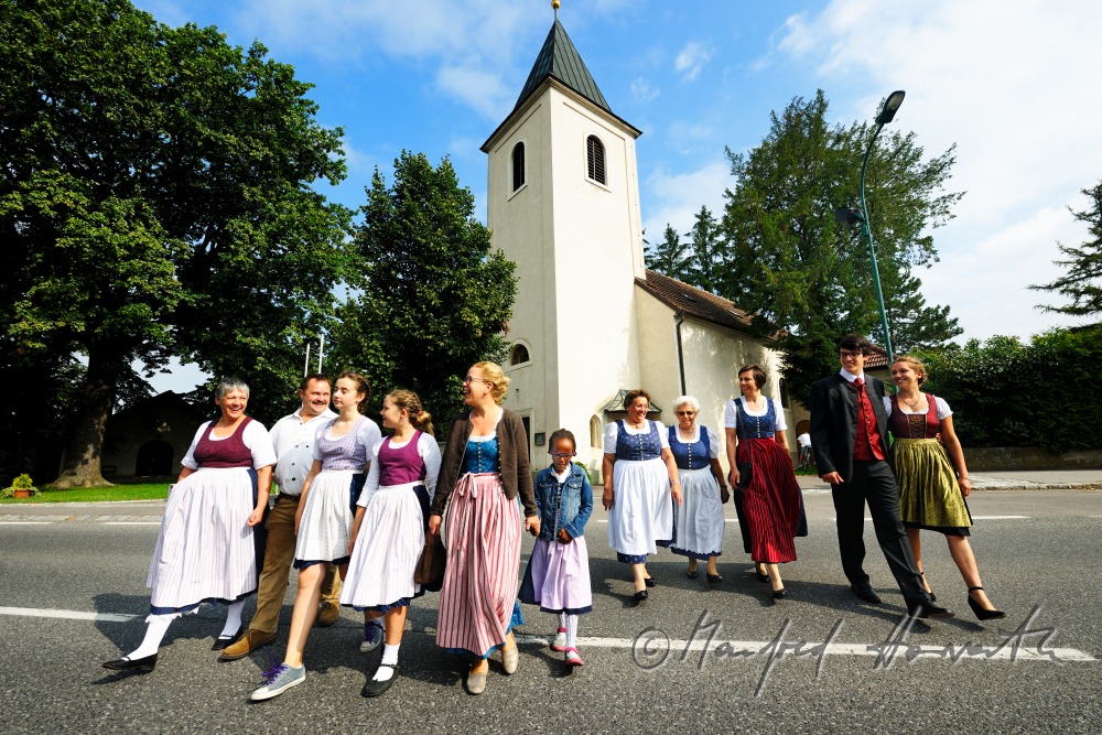 family coming out from church on Sunday in traditional dresses