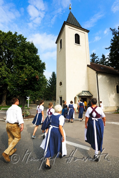 family going to church on Sunday in traditional dresses