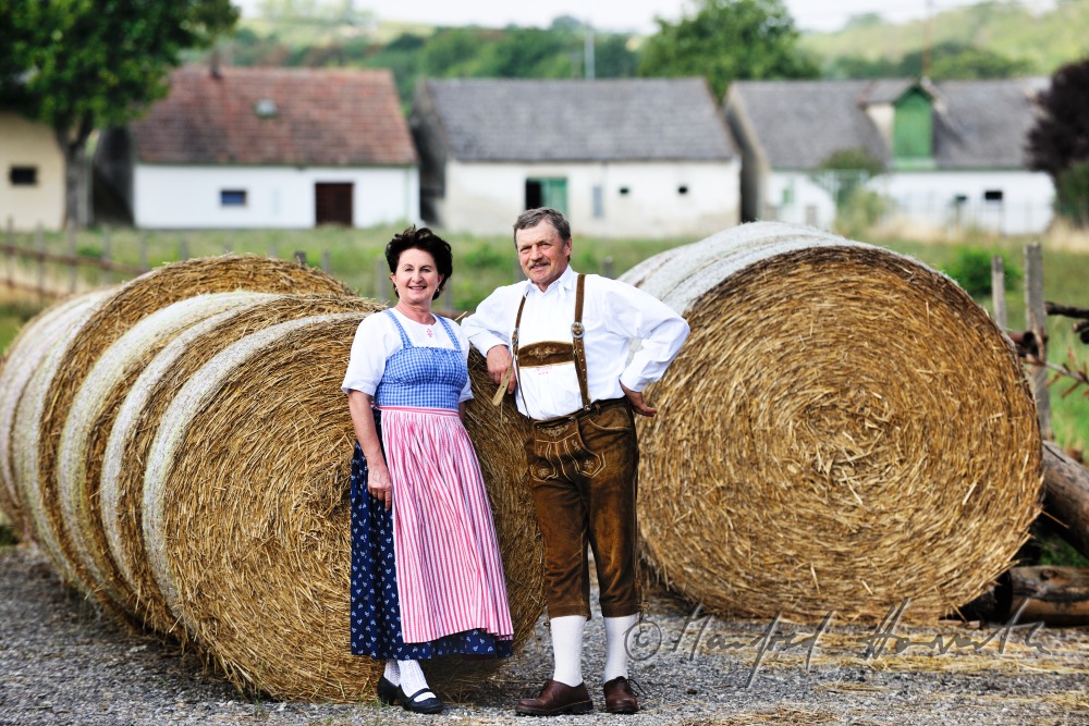 farmers in traditional clothes at their farm