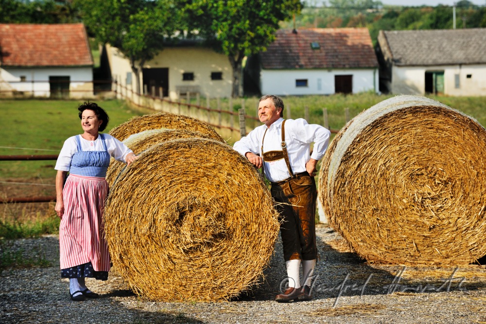 farmers in traditional clothes at their farm