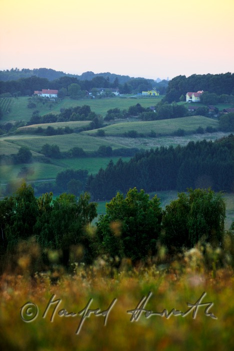 typical hilly landscape with scattered small farm houses