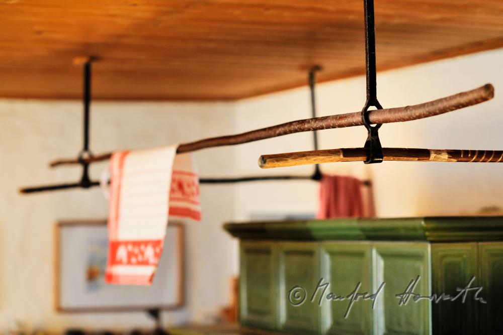 kitchen towels drying near the tile stove