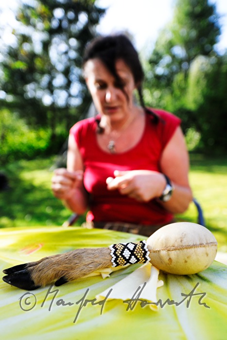 rattle with a goat leg for a handle