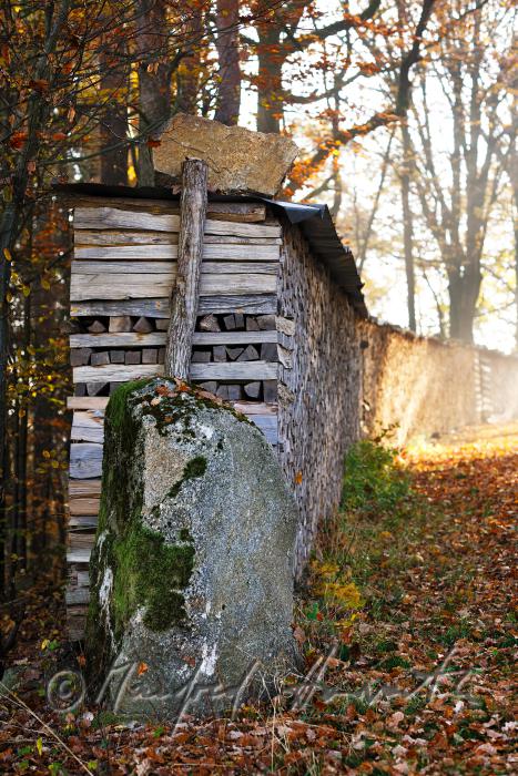 pile of wood with a granite boulder as linchpin