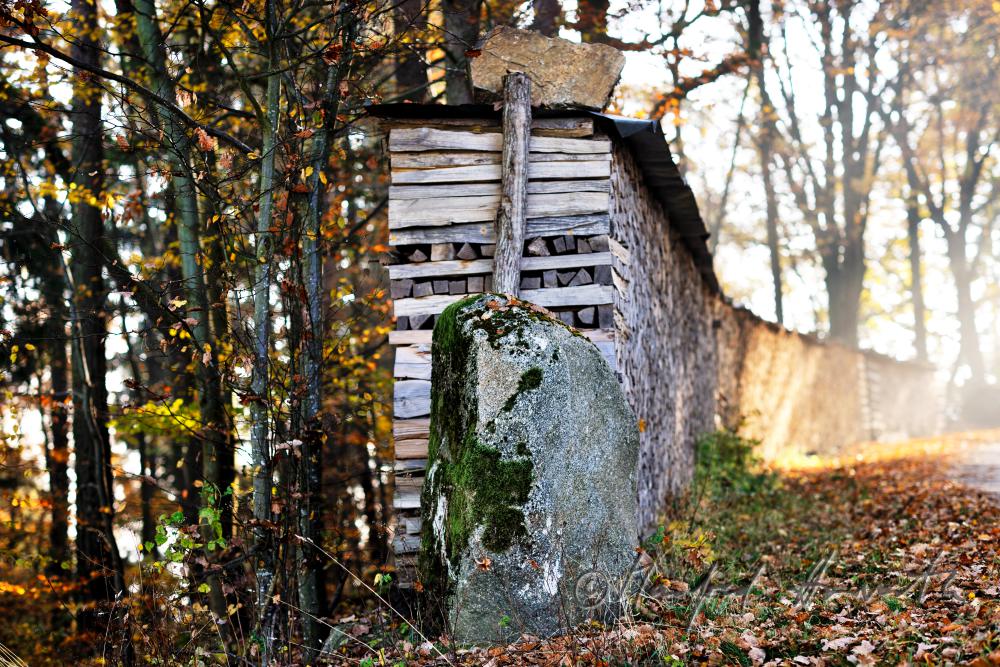 pile of wood with a granite boulder as linchpin