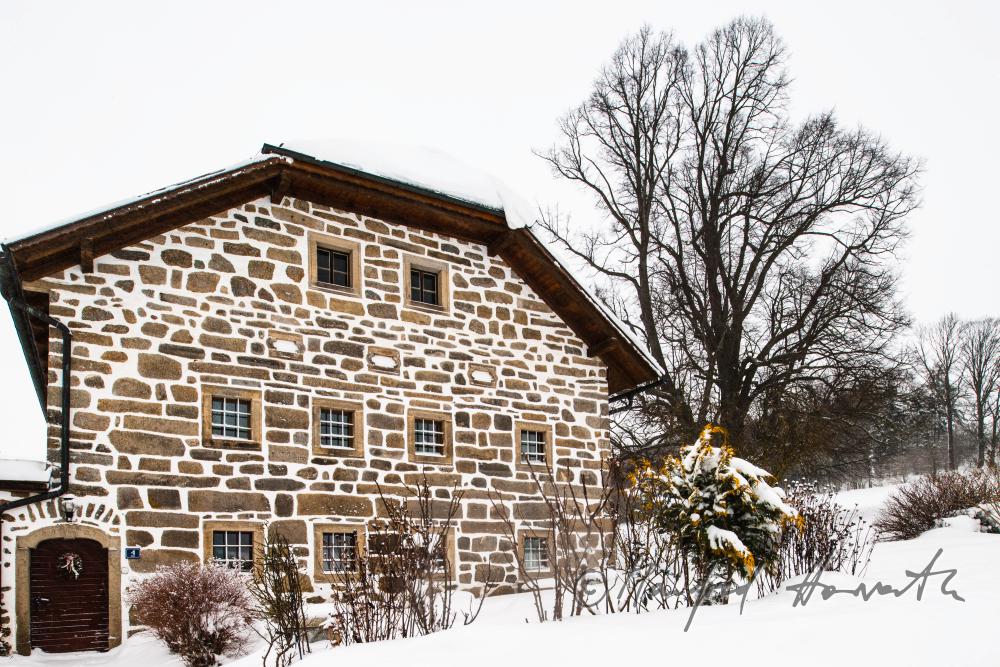 fassade of a typical farmhouse built of granite
