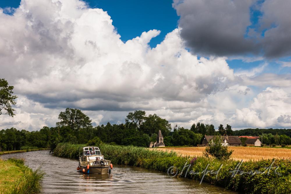 house boat passing a chapel near the town of Rully