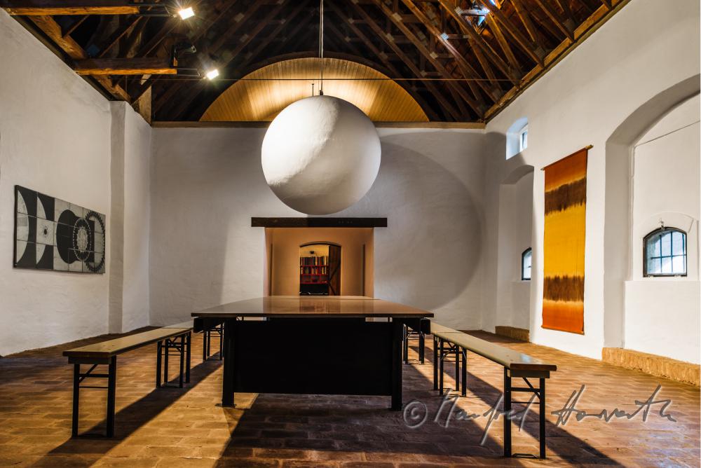 living room with frame-work roof and brick floor