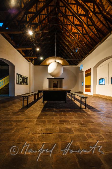 living room with frame-work roof and brick floor