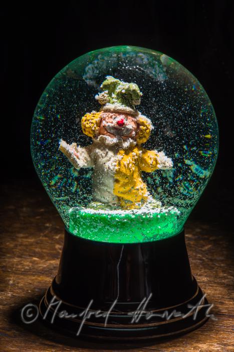 miniature clown in a scow globe