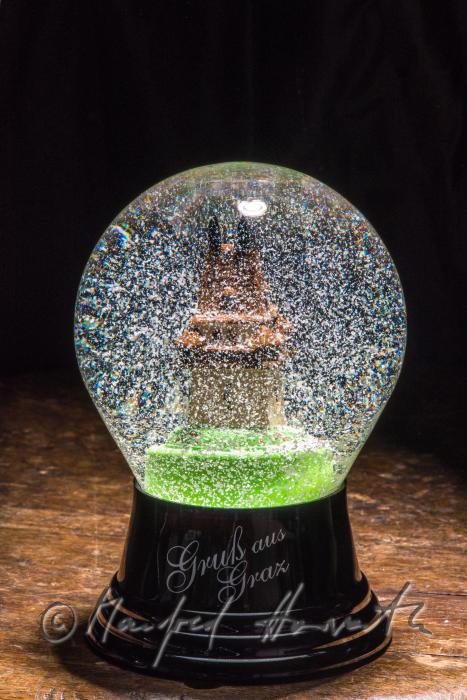 miniature of the Grazer Uhrturm in a snow globe