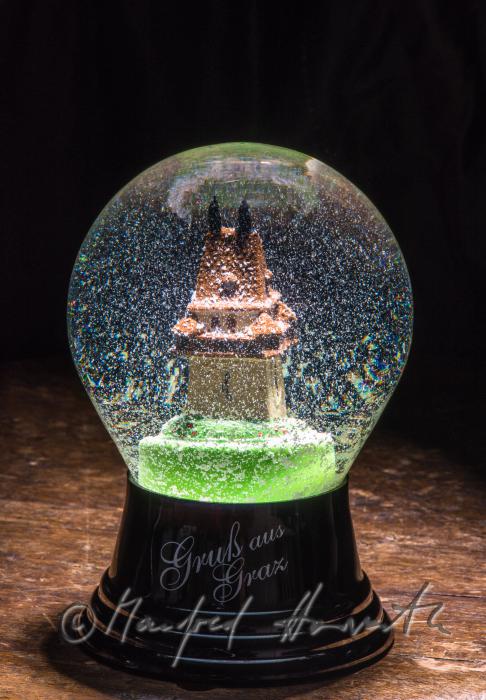 miniature of the Grazer Uhrturm in a snow globe