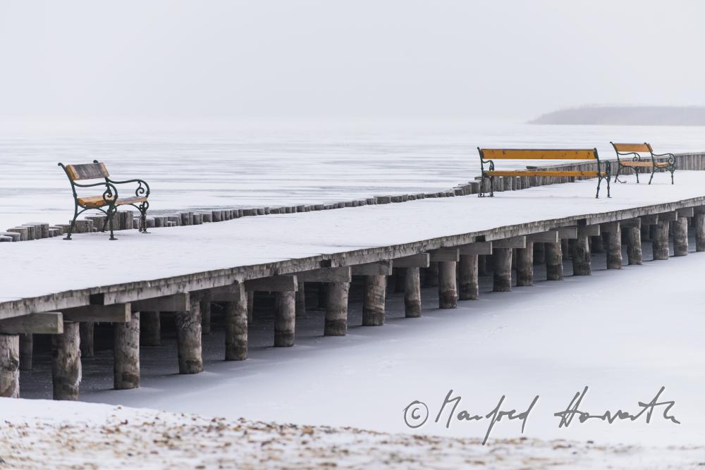 pontoon and park benches on the shore of the lake