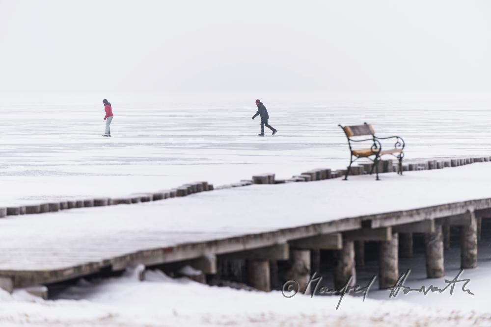 pontoon and park benches on the shore of the lake