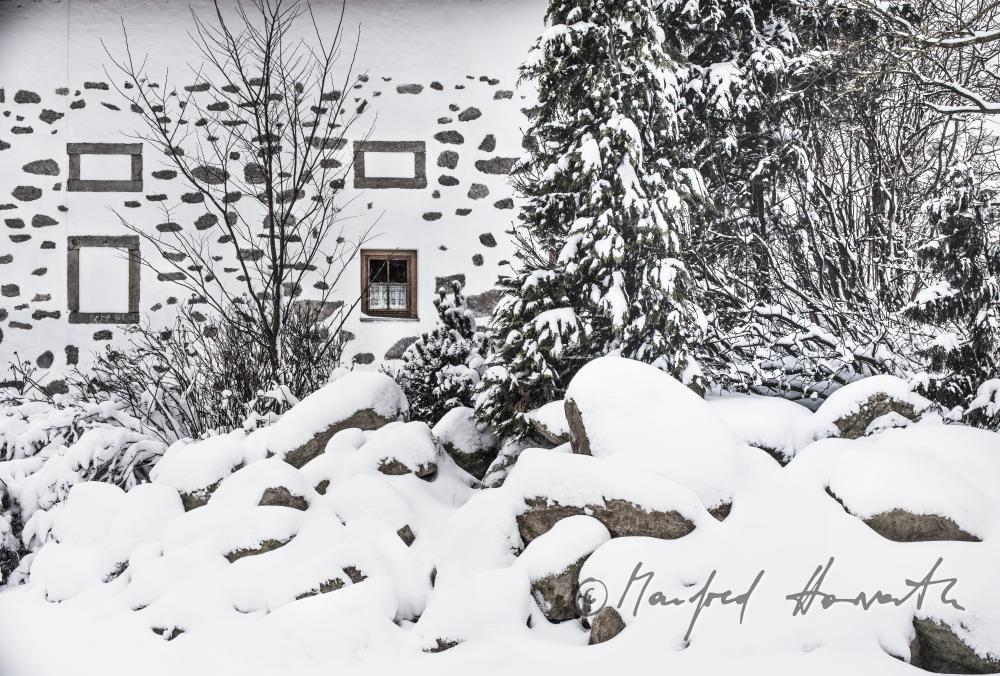 fassade of a typical farmhouse built of granite