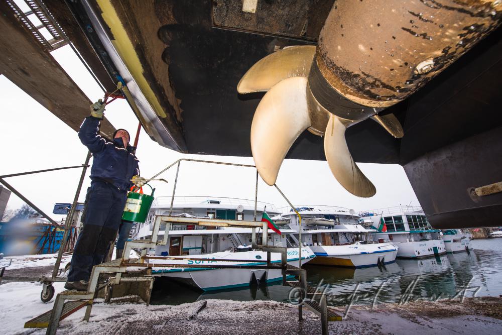 painting a ship in the drydock of the wharf