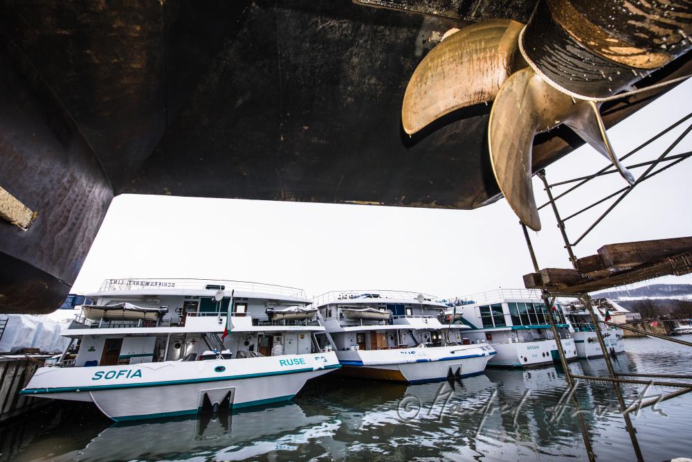 painting a ship in the drydock of the wharf