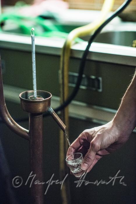 making of Schnaps in the cellar of a farmhouse