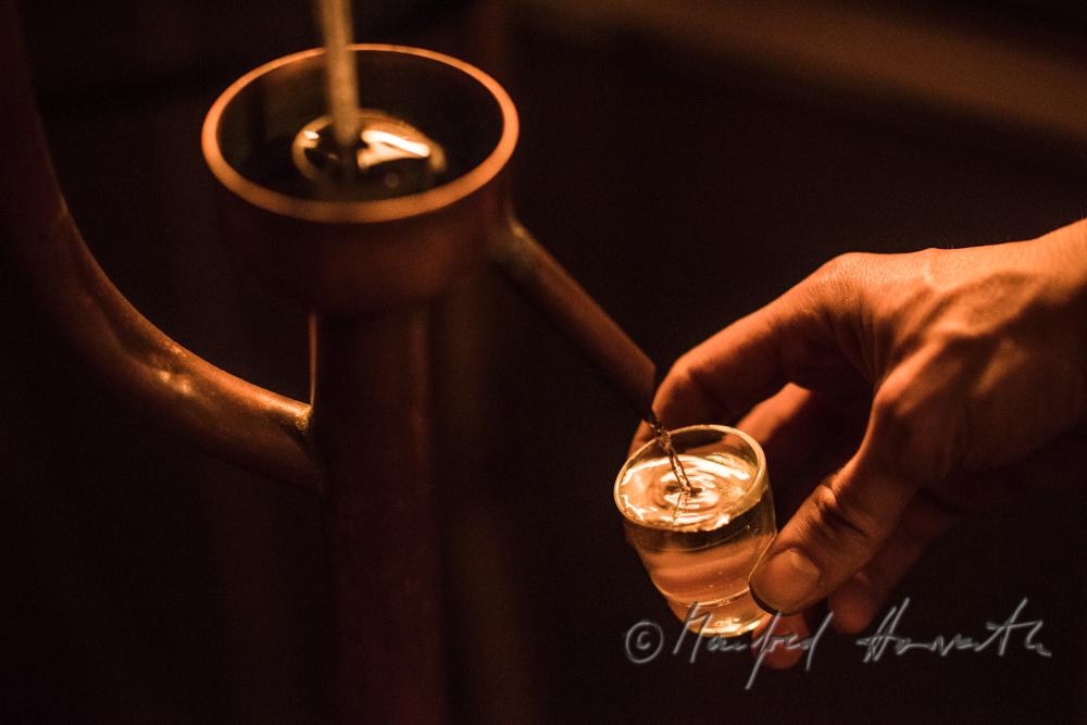 making of Schnaps in the cellar of a farmhouse