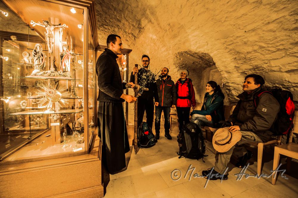 pilgrims with monk in the collection of relics