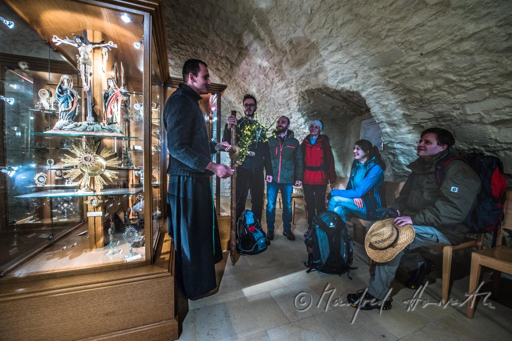 pilgrims with monk in the collection of relics