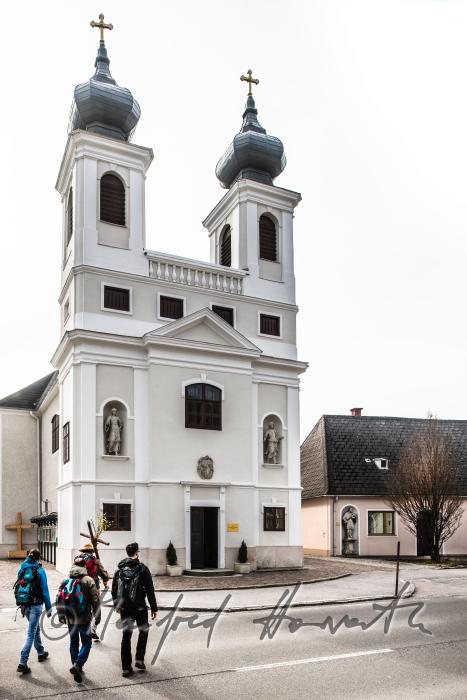pilgrims passing the church