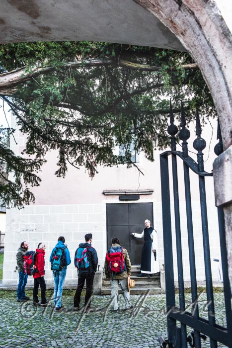 pilgrims and priest near the church 