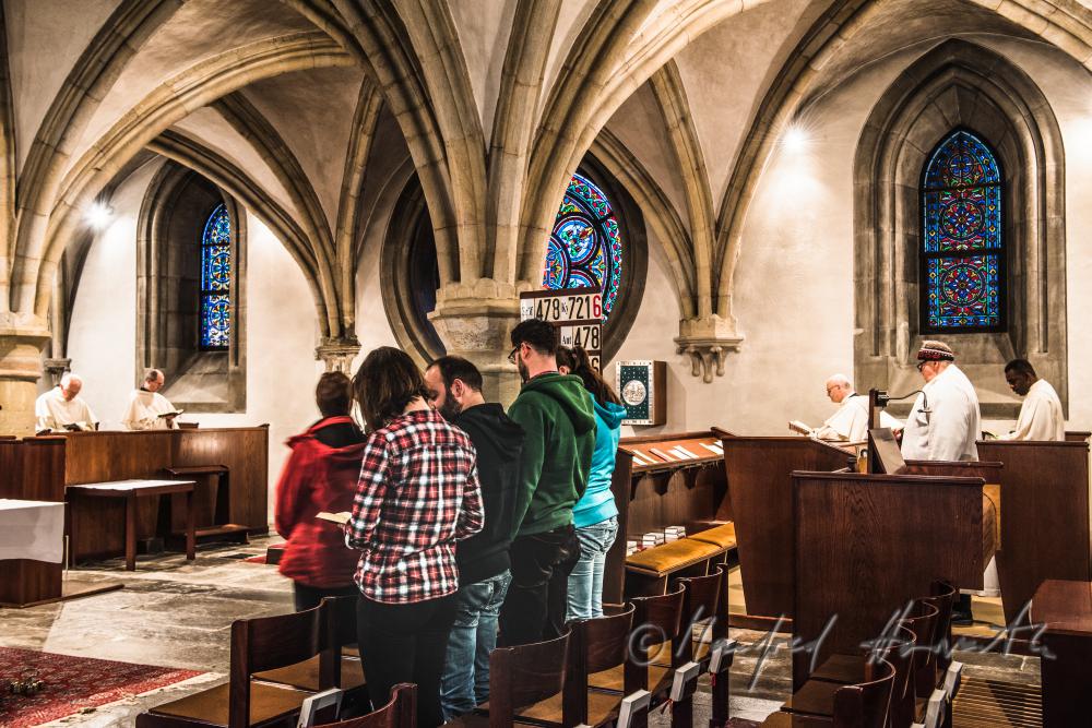pilgrims at a mass with the monks