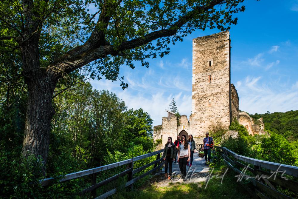 medieval Castle Kaja and hikers on the bridge