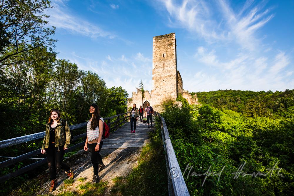 medieval Castle Kaja and hikers on the bridge