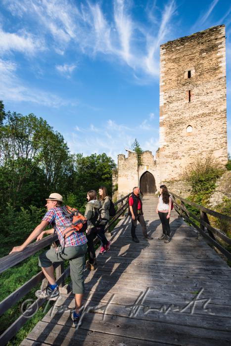 medieval Castle Kaja and hikers on the bridge