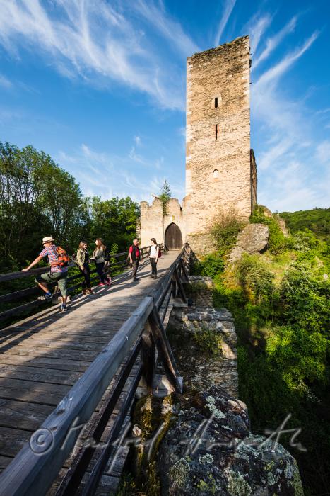 medieval Castle Kaja and hikers on the bridge