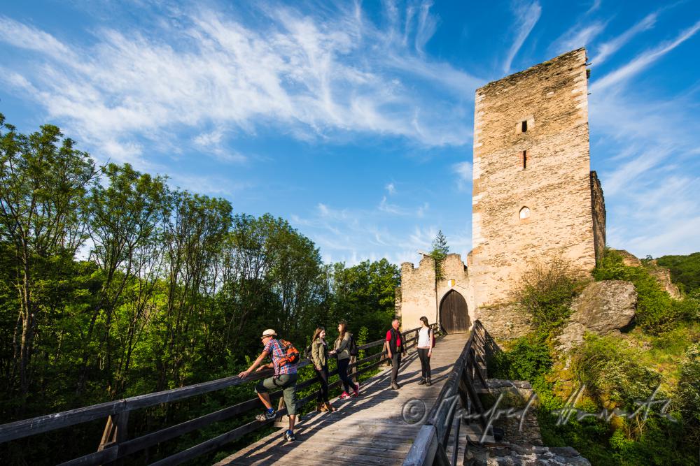 medieval Castle Kaja and hikers on the bridge