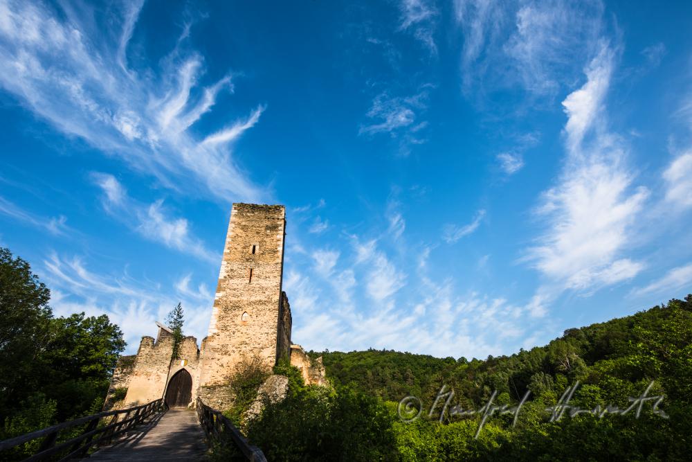 medieval Castle Kaja and hikers on the bridge